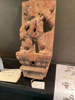 Wall-mount with carved figure